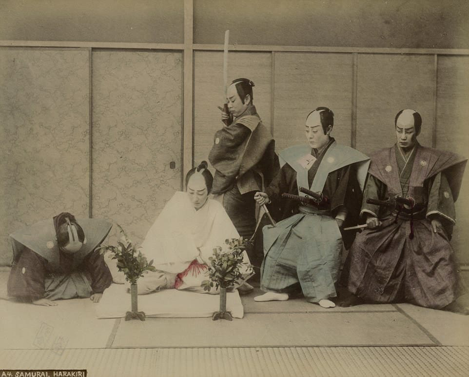 Historical staged photograph of a seppuku ceremony with kaishakunin and seated witnesses