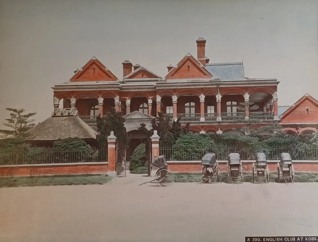 Photograph of the English Club in Kobe, 1884 — rickshaws and Western architecture